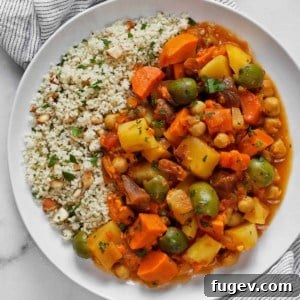 Root vegetable tagine with lemon almond couscous served on a plate