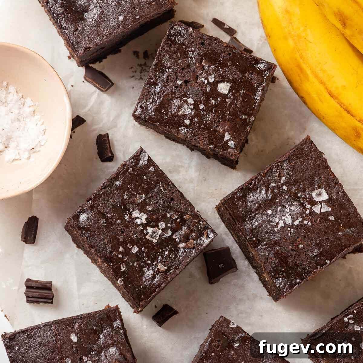 Fudgy Banana Brownies 3 Perfectly ripe bananas, ideal for baking, resting beside freshly baked banana brownie squares.