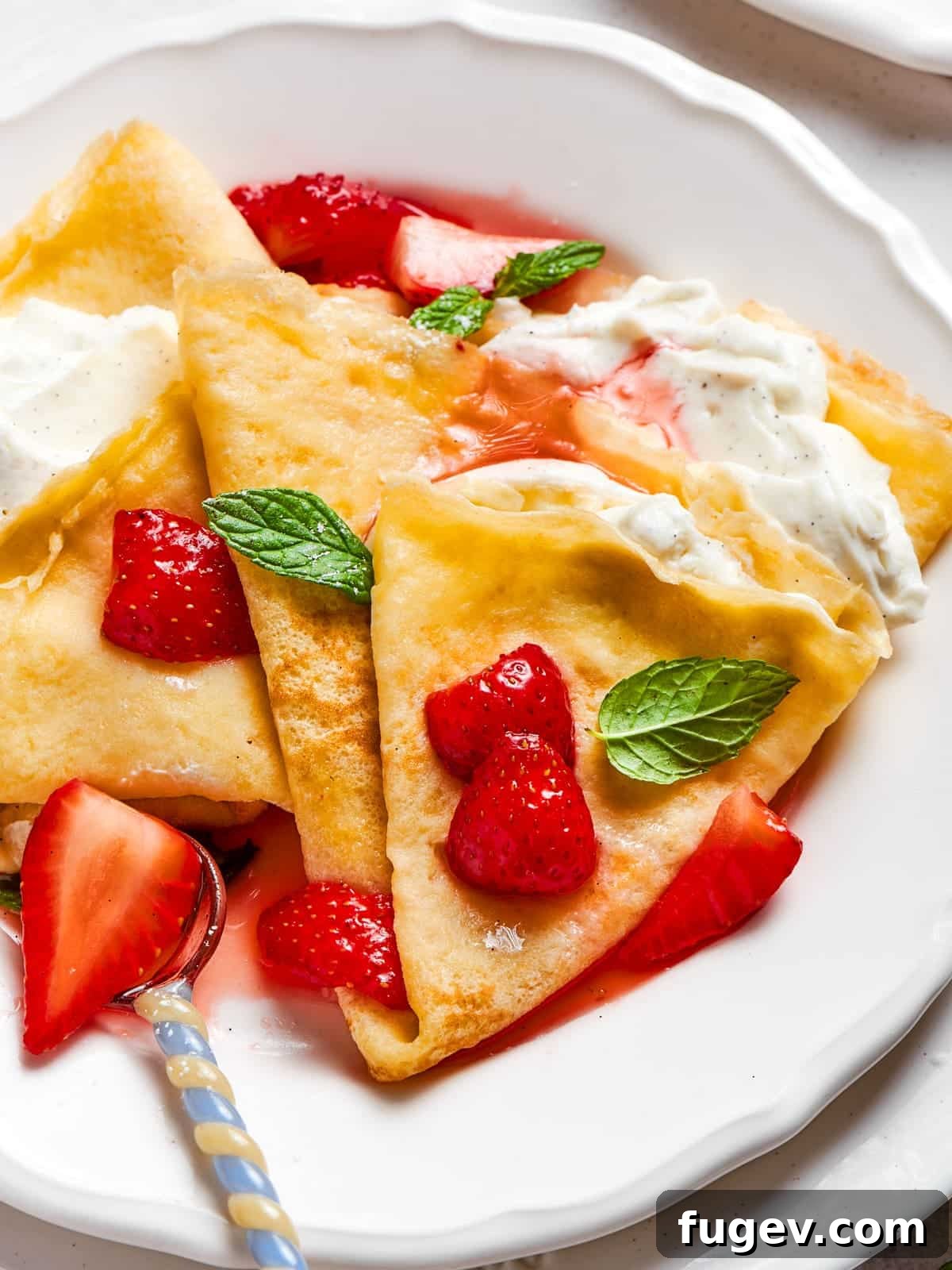 Easy Sweet Crepe Perfection 2 Bright red strawberry crepes folded neatly and served warm with a soft, tender texture, inviting for breakfast or dessert.