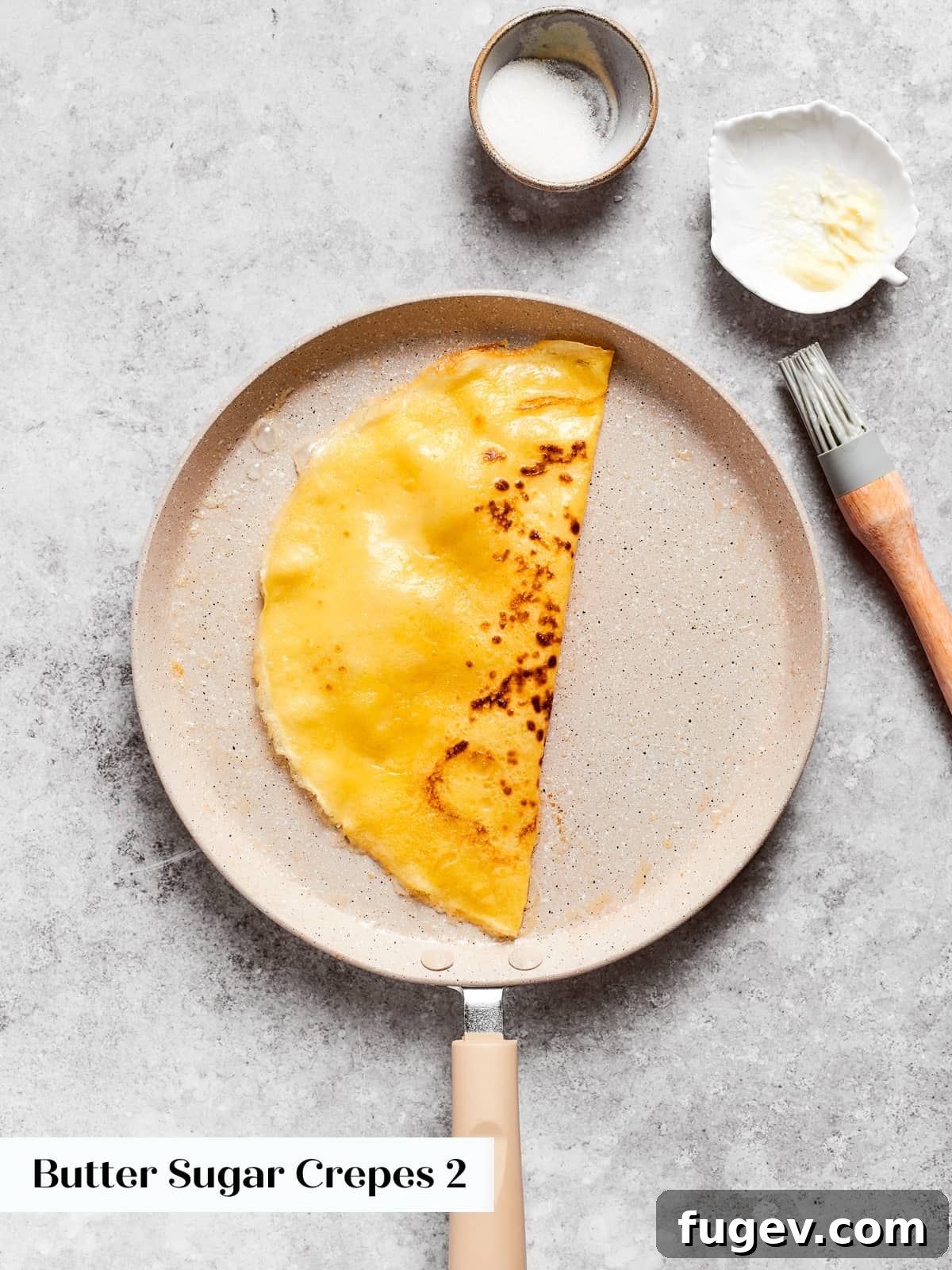 Easy Sweet Crepe Perfection 11 Soft crepe folded neatly in half, preparing for fillings like butter and sugar or fresh fruit.