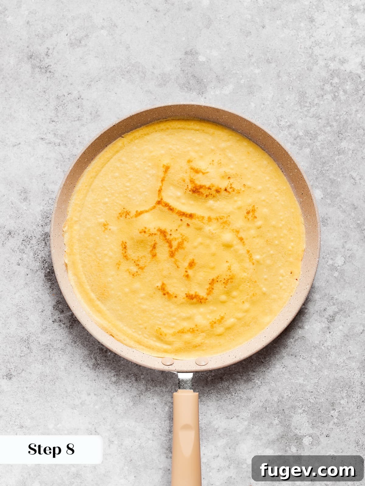 Easy Sweet Crepe Perfection 9 Freshly flipped crepe revealing a warm golden hue and delicate texture in the skillet, almost ready to serve.