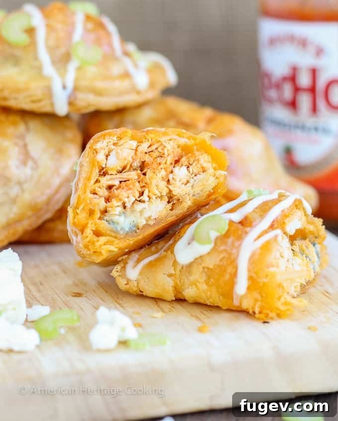 Spicy Buffalo Blue Cheese Pockets 4 A stack of Buffalo Chicken Blue Cheese Hand Pies, highlighting their individual size and golden crust, making them ideal for sharing.