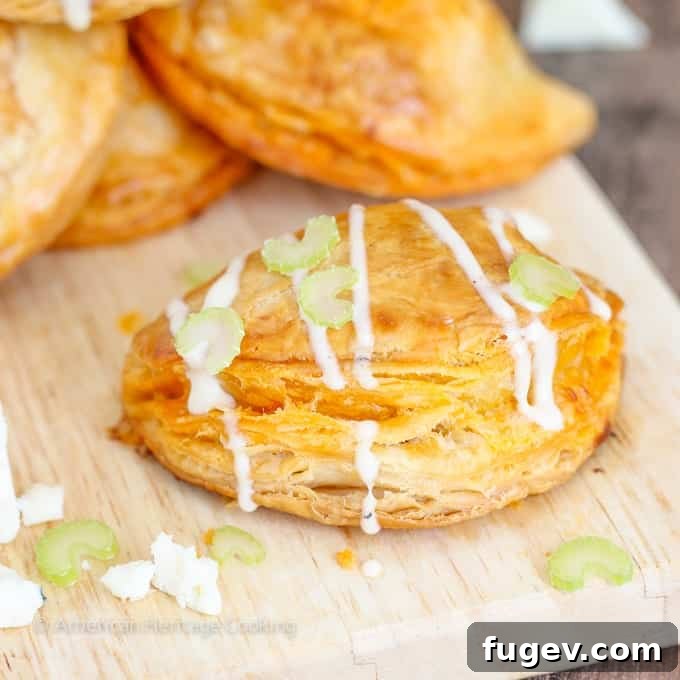 Spicy Buffalo Blue Cheese Pockets 6 A close-up of a single Buffalo Chicken Blue Cheese Hand Pie, showcasing the golden, textured pastry crust.