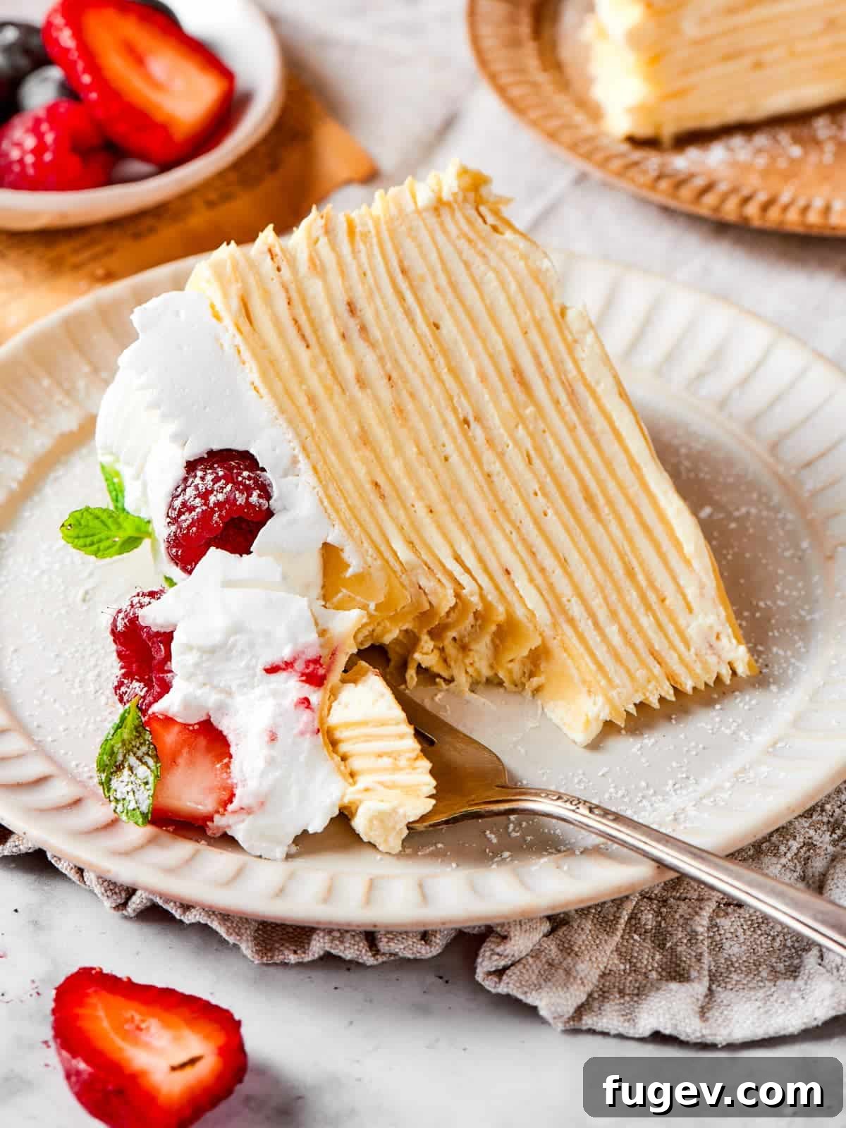 Silken Layered Crepe Delight 2 A small forkful of layered crepe cake lifted to show the tender texture and vanilla cream.