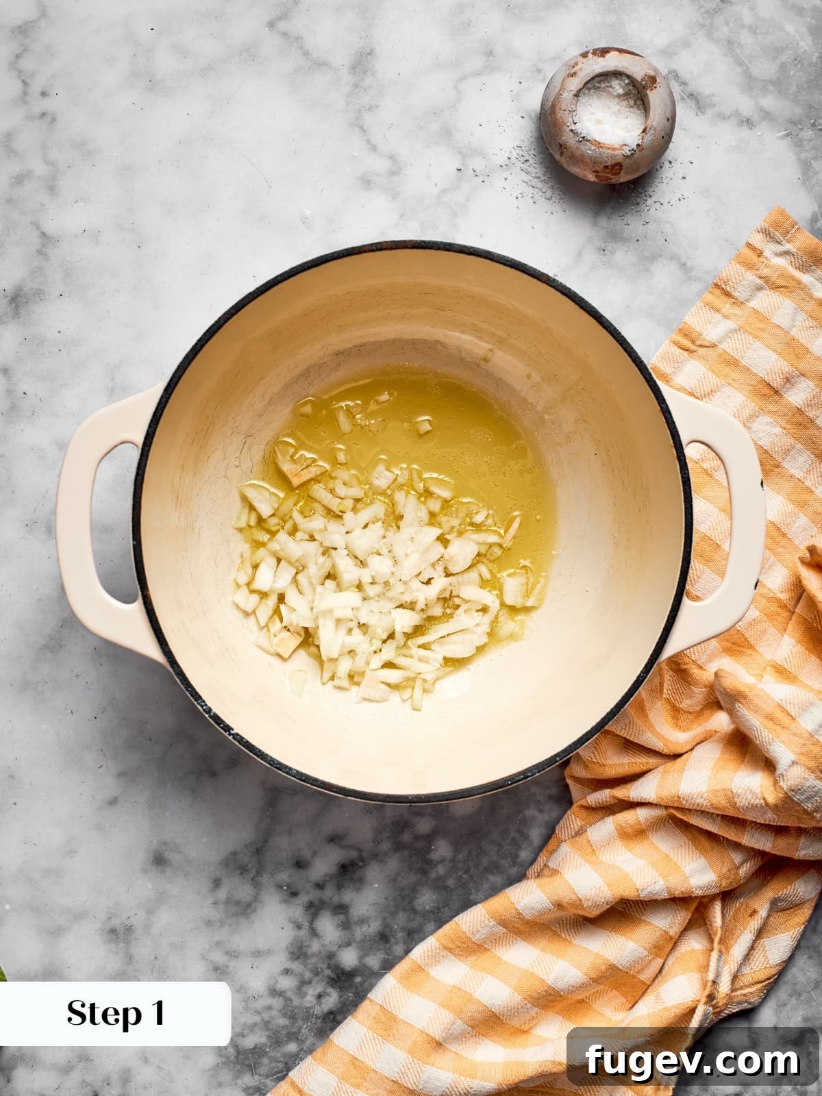 Creamy Vegan Pumpkin Harvest Soup 6 Diced yellow onions gently sautéing in olive oil in a saucepan, beginning to soften and turn translucent.