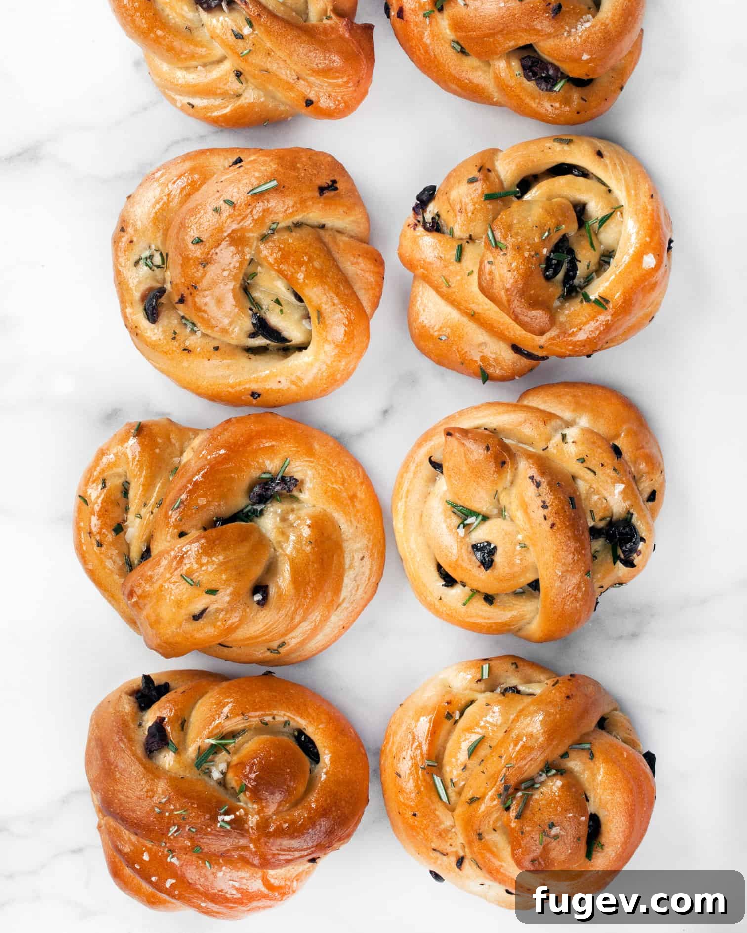 Savory Rosemary Olive Twists 3 Close-up of golden brown Rosemary Olive Knots in a rustic basket, highlighting the texture and visible olive pieces.