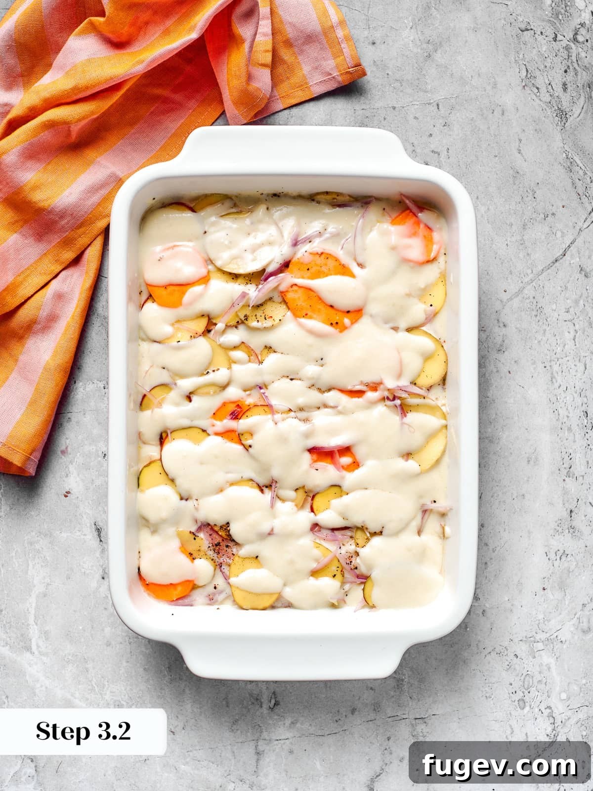 Effortless Scalloped Potato Perfection 11 Cheese sauce drizzled over layered potatoes during scalloped potatoes assembly.