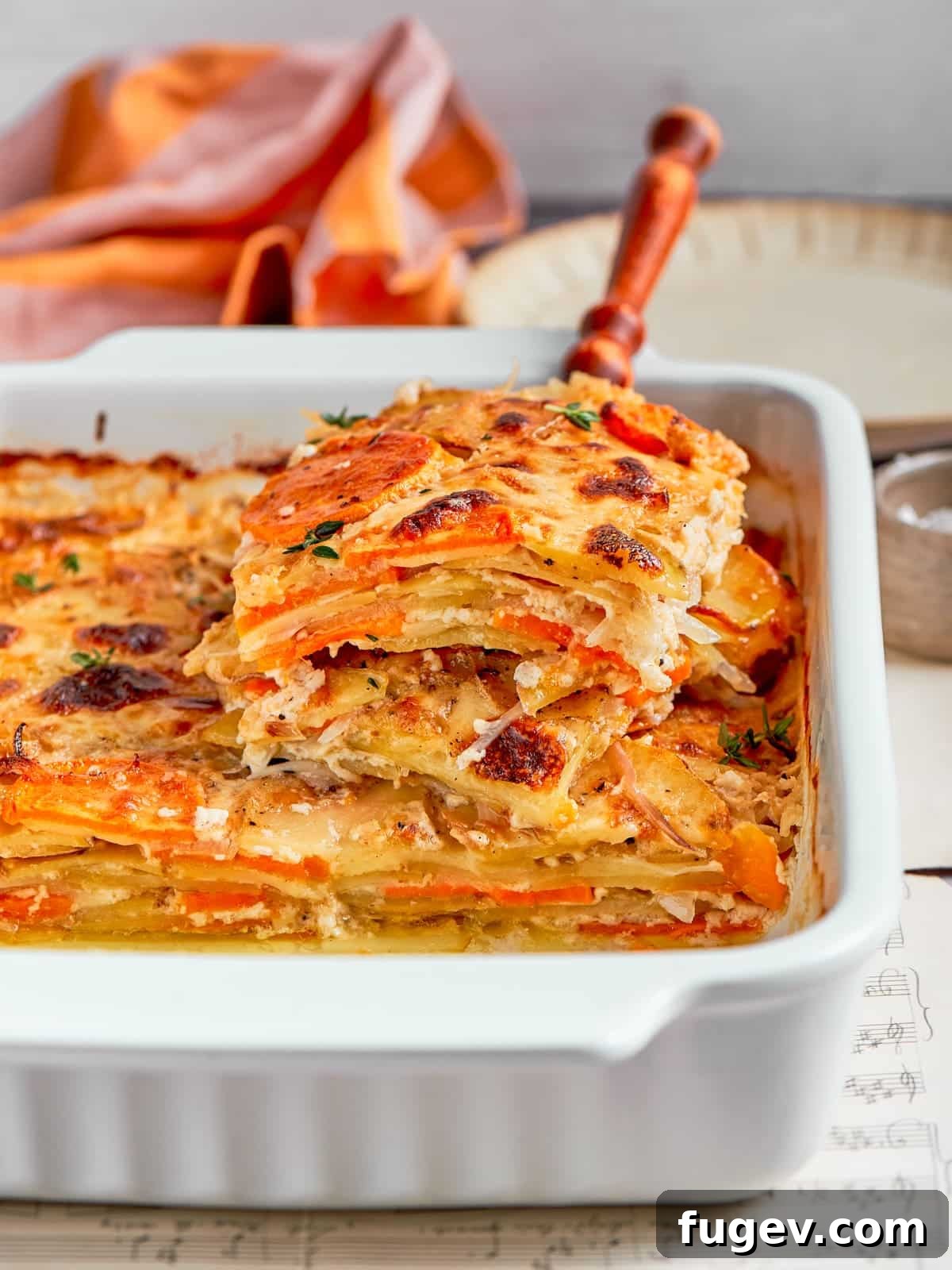 Effortless Scalloped Potato Perfection 13 Layered scalloped potatoes lifted from the dish showing creamy sauce and tender slices.