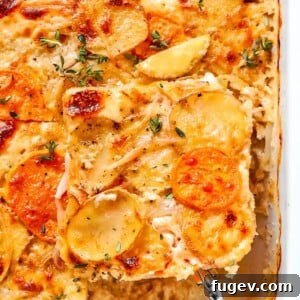 Neatly cut square of scalloped potatoes being served from baking dish.