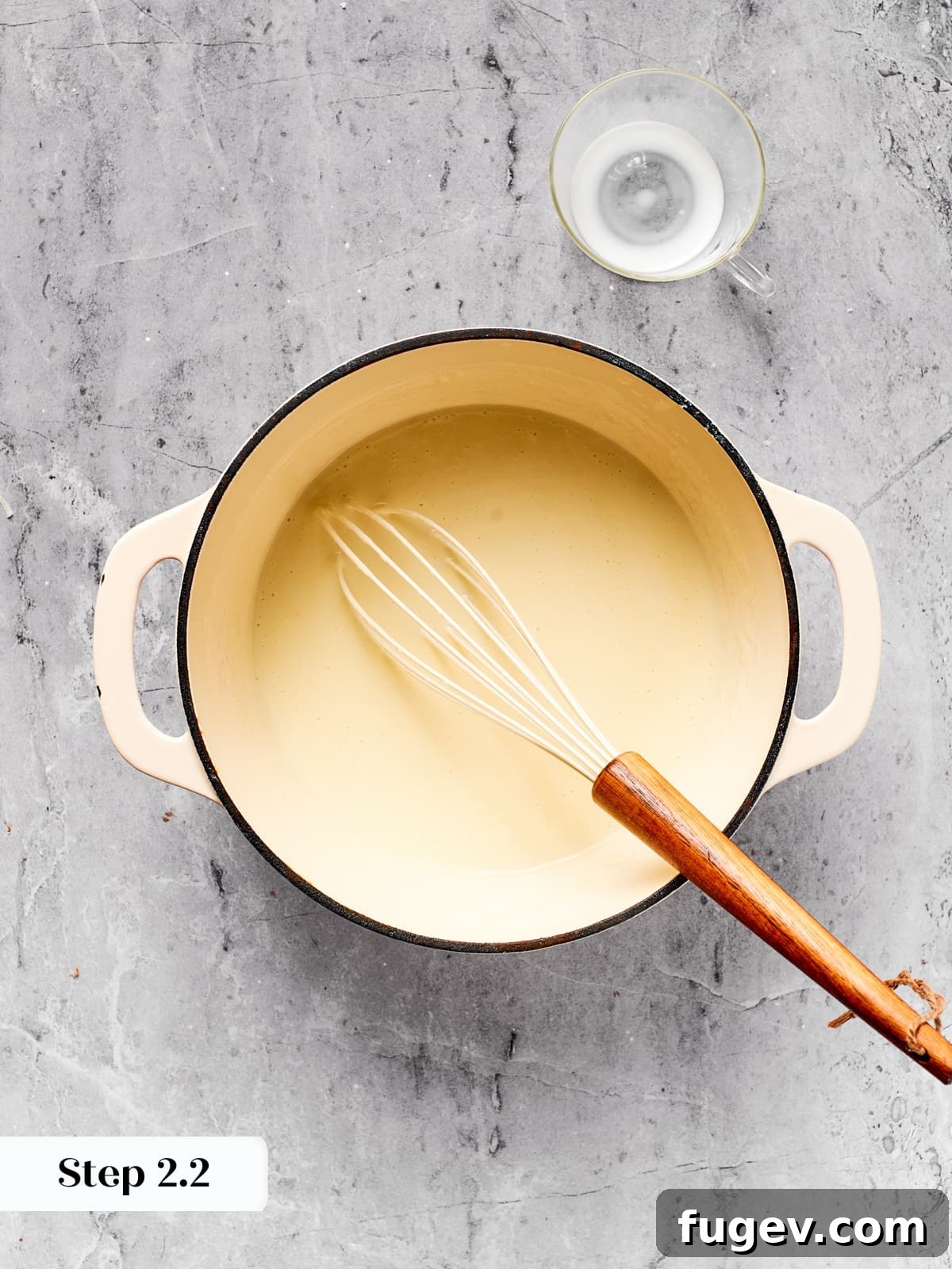 Effortless Scalloped Potato Perfection 8 Saucepan with thickening milk and roux whisked until smooth and creamy.