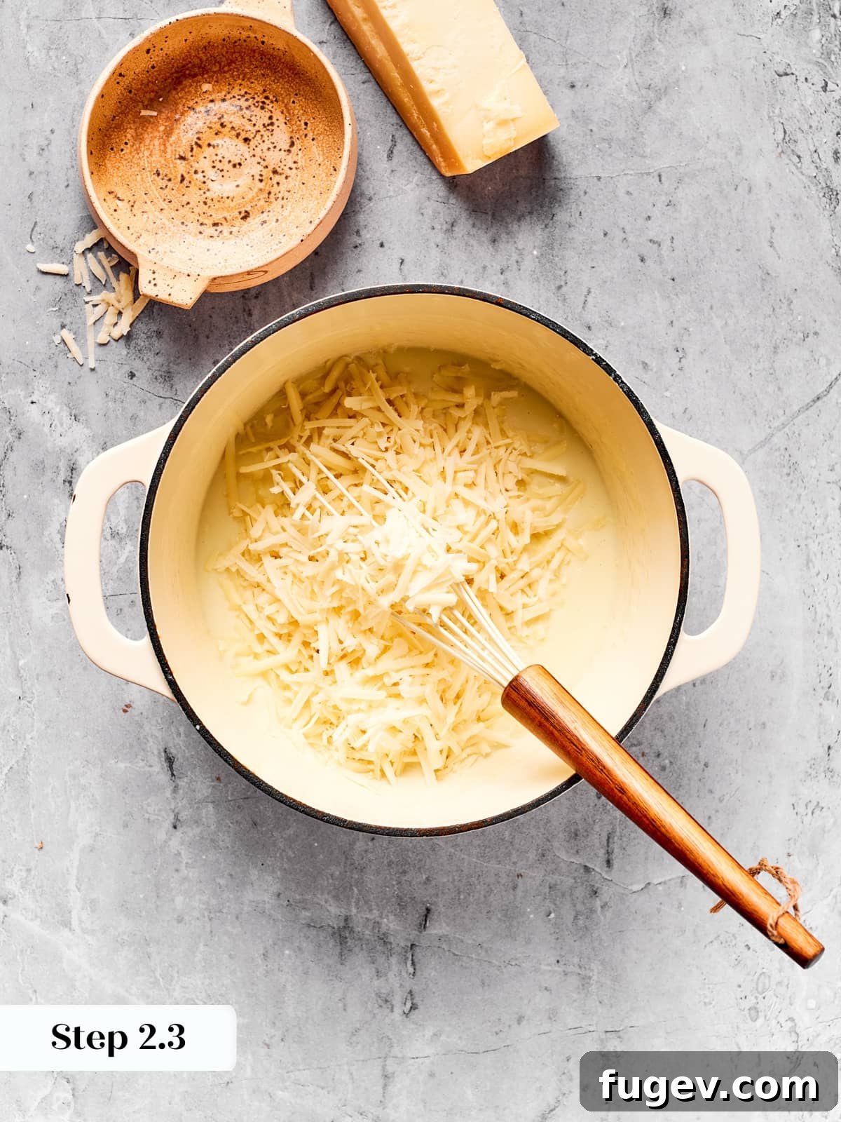 Effortless Scalloped Potato Perfection 9 Cheese melting into béchamel to create a creamy cheddar sauce.