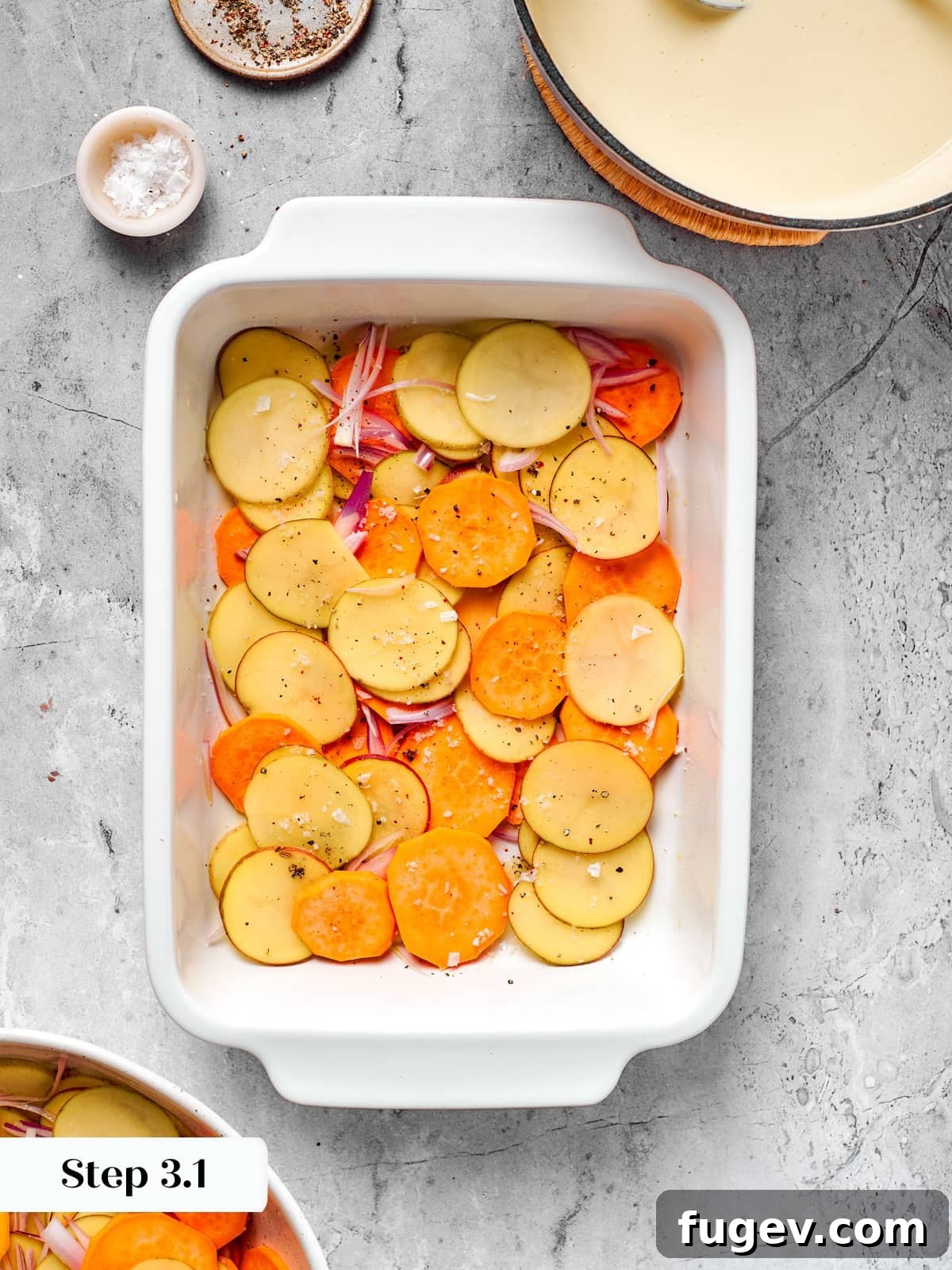 Effortless Scalloped Potato Perfection 10 First layer of thin sliced potatoes and shallots arranged in baking dish.