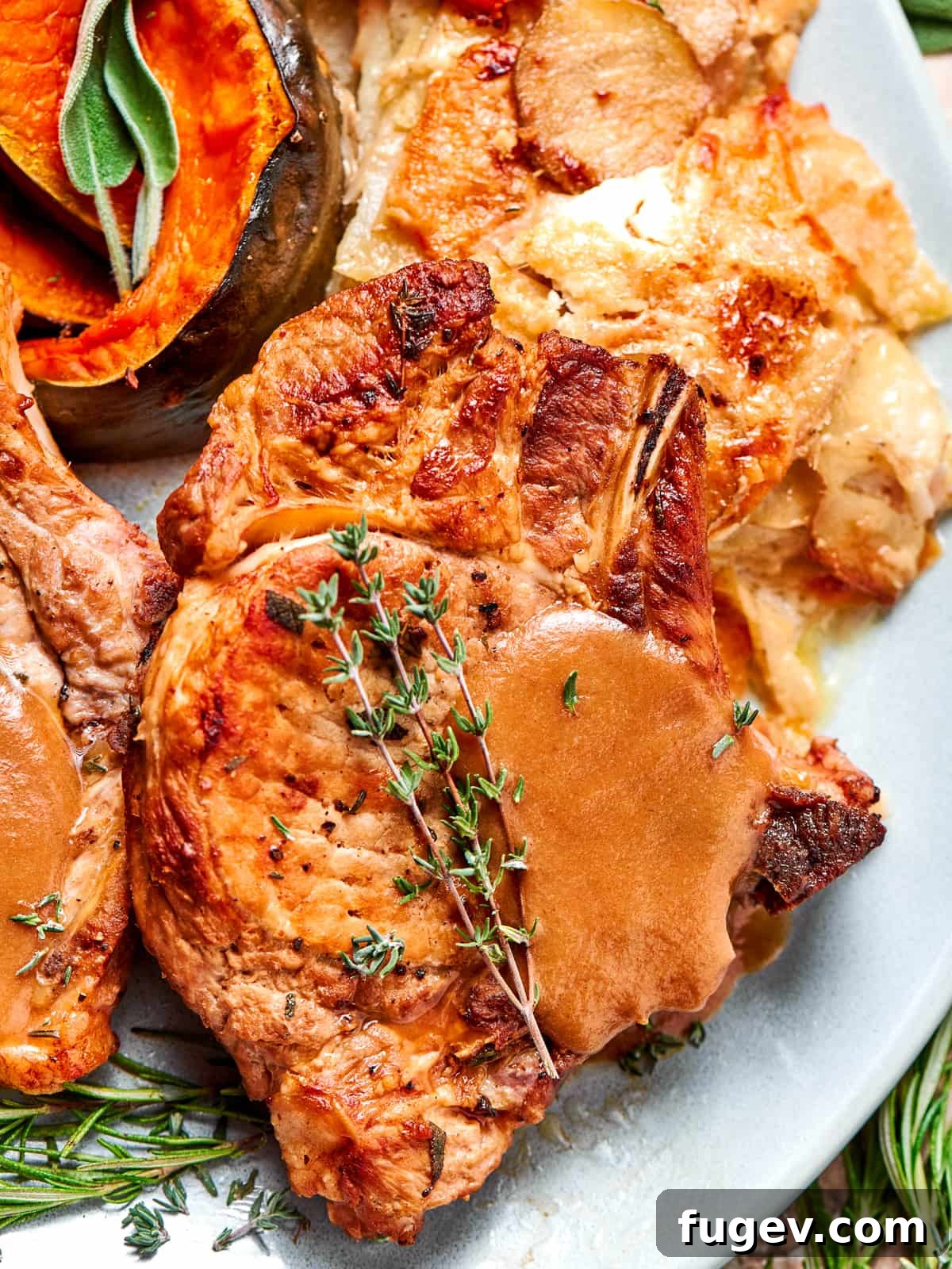 Succulent Pork with Warm Apple Compote 13 A perfectly cooked pork chop generously topped with smooth applesauce sauce and garnished with fresh thyme leaves, ready to be enjoyed.