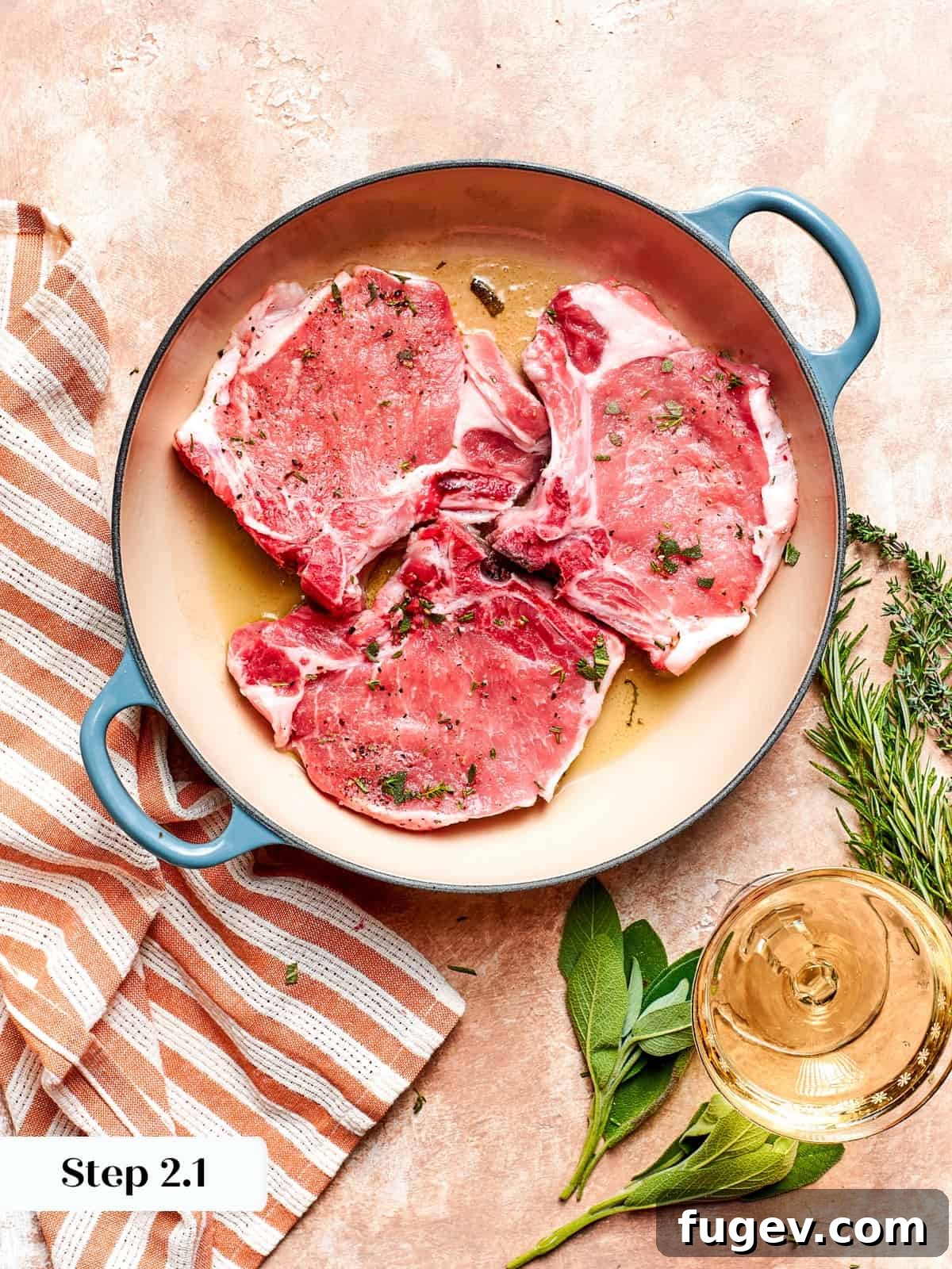 Succulent Pork with Warm Apple Compote 7 Herb-seasoned pork chops beginning to sear in a hot pan, showing the initial browning process.