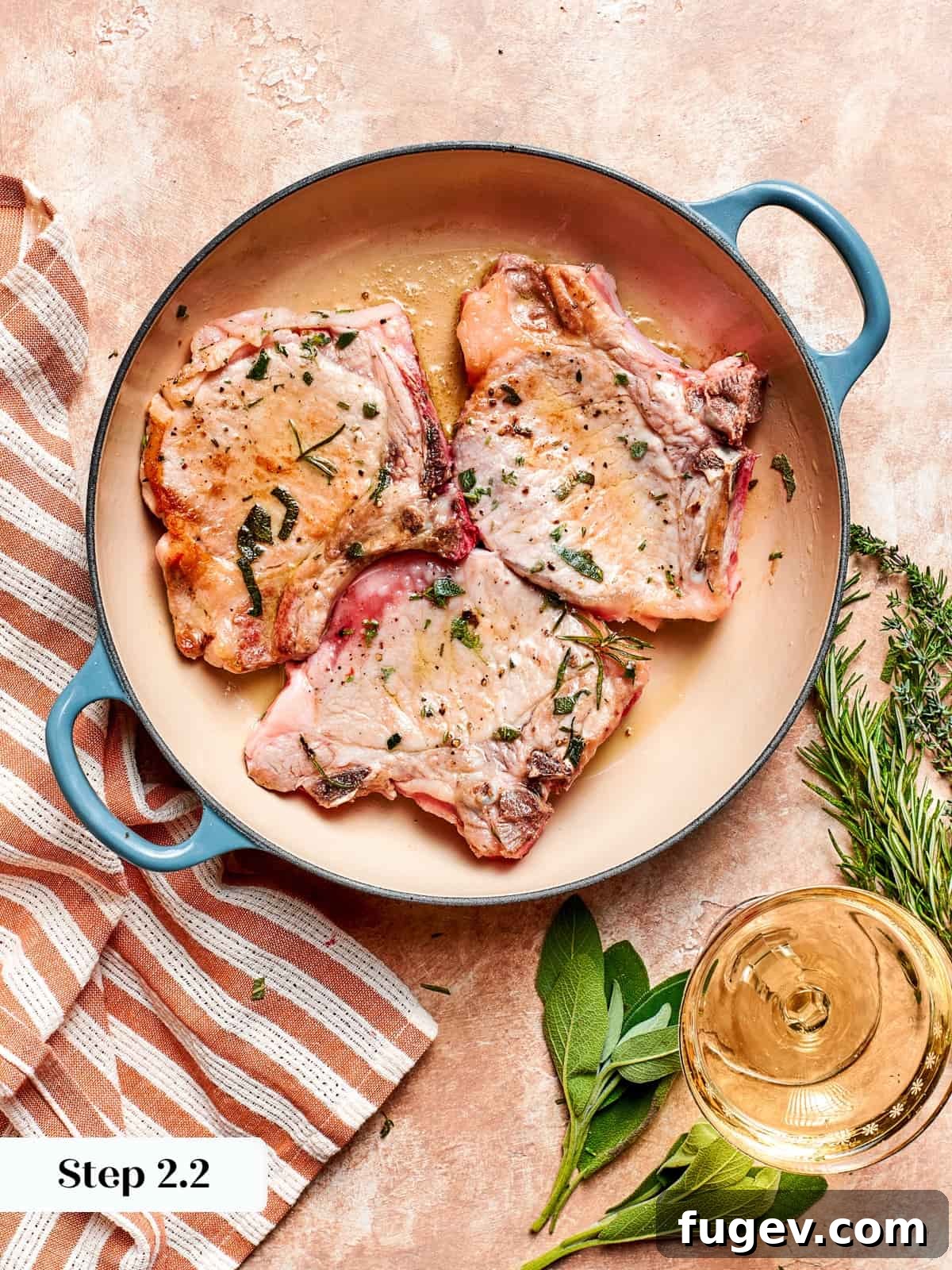 Succulent Pork with Warm Apple Compote 8 Pork chops beautifully flipped in a hot skillet, revealing an even golden-brown crust on the first side as the second side begins to cook.
