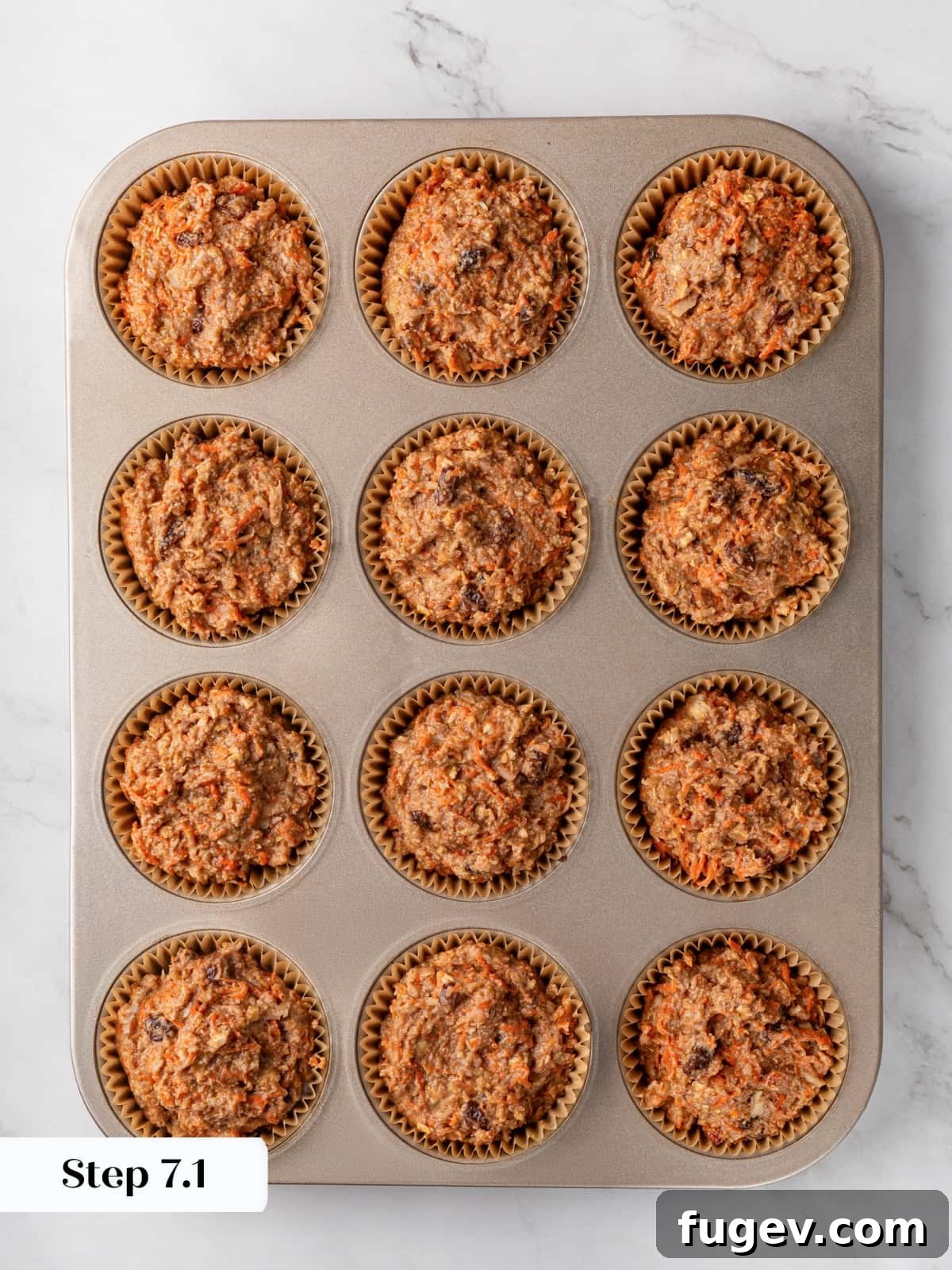 Morning Glow Muffins 11 Muffin batter portioned into lined tin cups before baking in oven evenly.