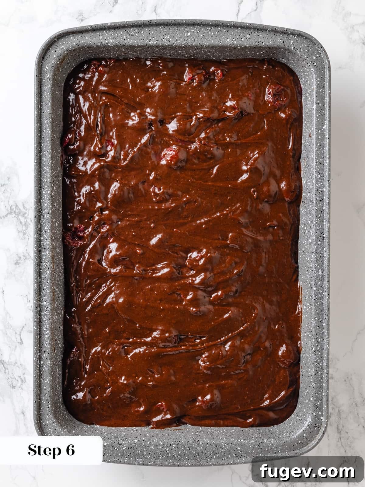 Velvet Chocolate Cherry Indulgence 14 Chocolate cherry cake batter expertly poured into a prepared baking pan, ready for the oven.