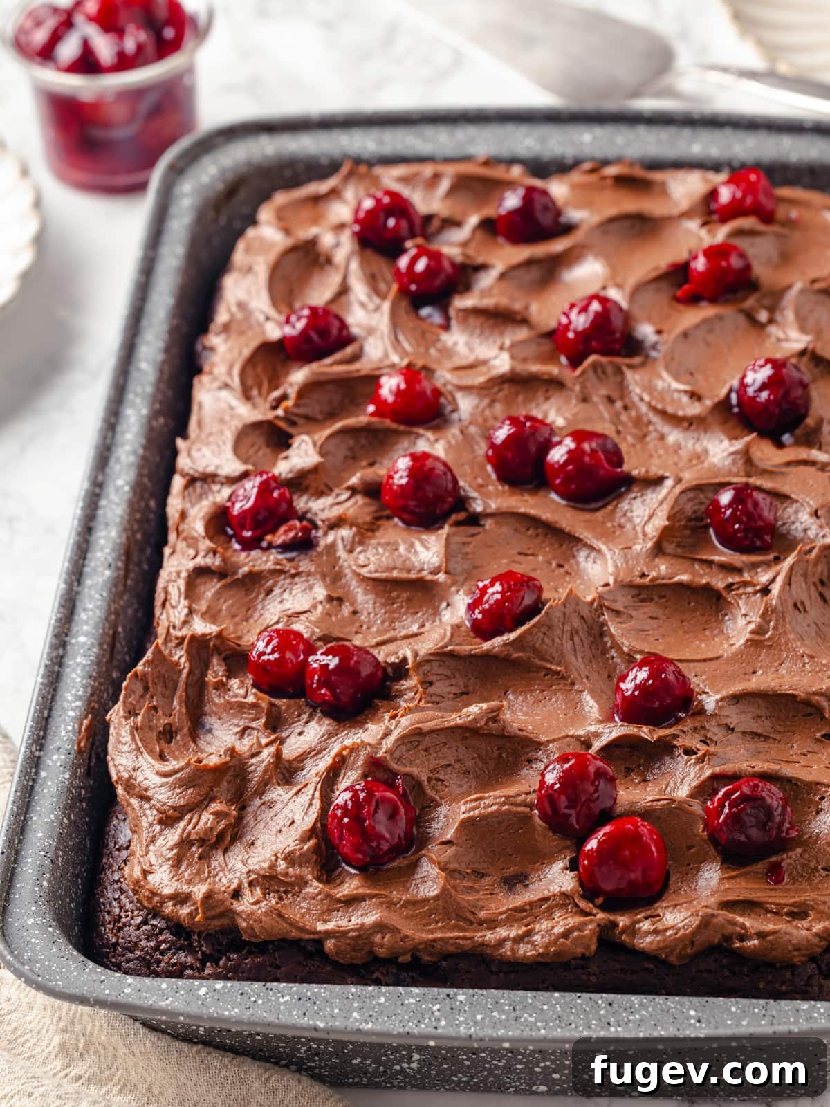 Velvet Chocolate Cherry Indulgence 22 Chocolate cherry cake decadently topped with generous cherry pie filling and soft, swirled chocolate frosting.
