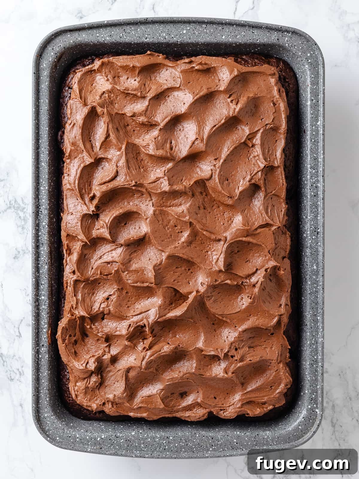Decadent Chocolate Cream Cheese Dream 2 Silky chocolate cream cheese frosting spread artfully, showcasing its soft waves and smooth, rich texture.