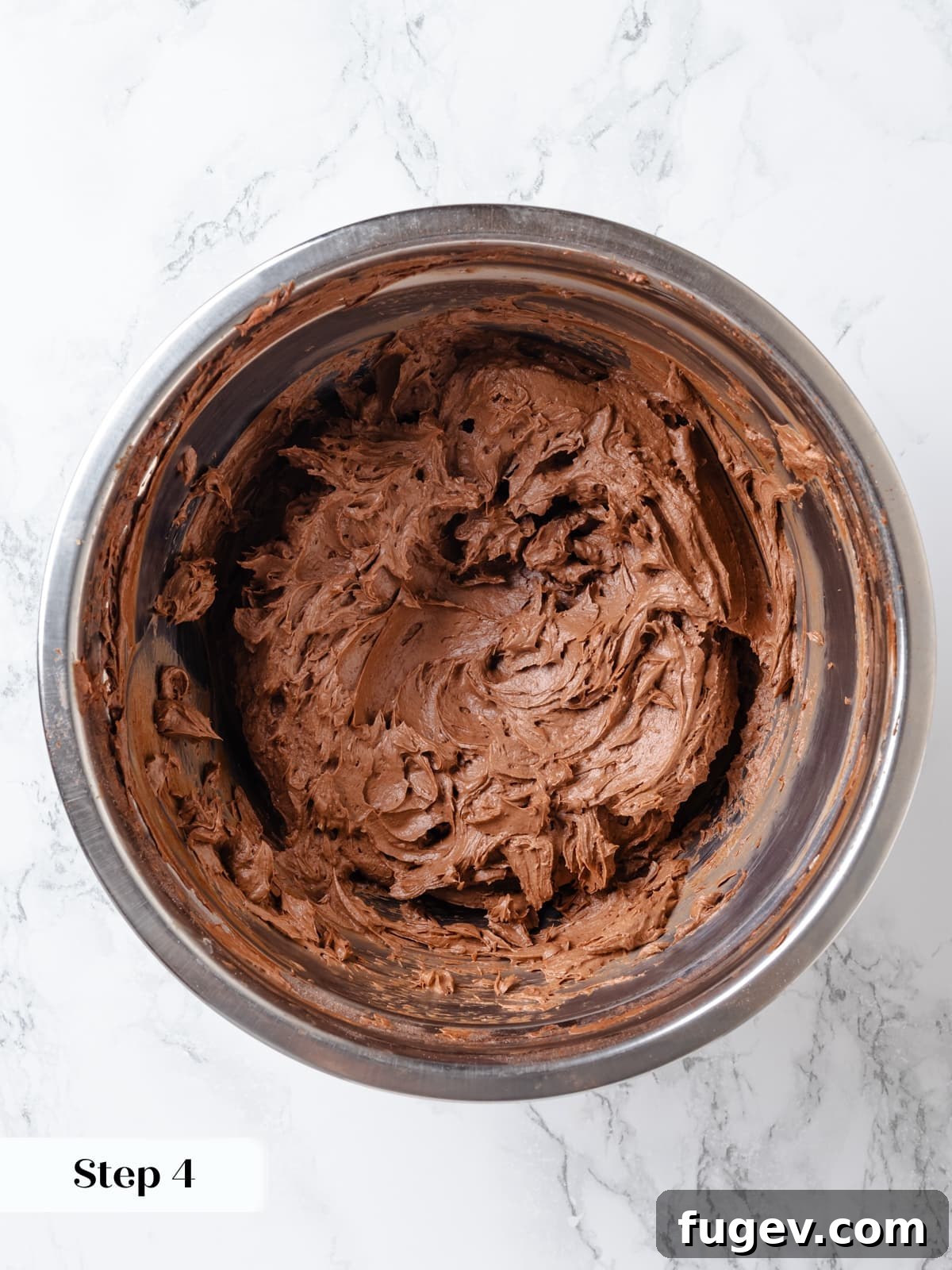 Decadent Chocolate Cream Cheese Dream 8 Fluffy chocolate cream cheese frosting, aerated and light, showcased in a mixing bowl with the whisk attachment.