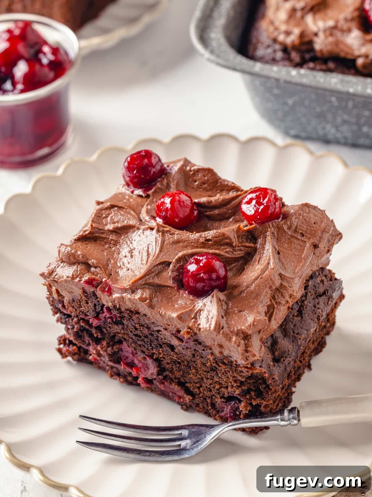 Decadent Chocolate Cream Cheese Dream 9 A rich chocolate cake, beautifully topped with creamy chocolate cream cheese frosting, elegantly placed on a decorative plate.