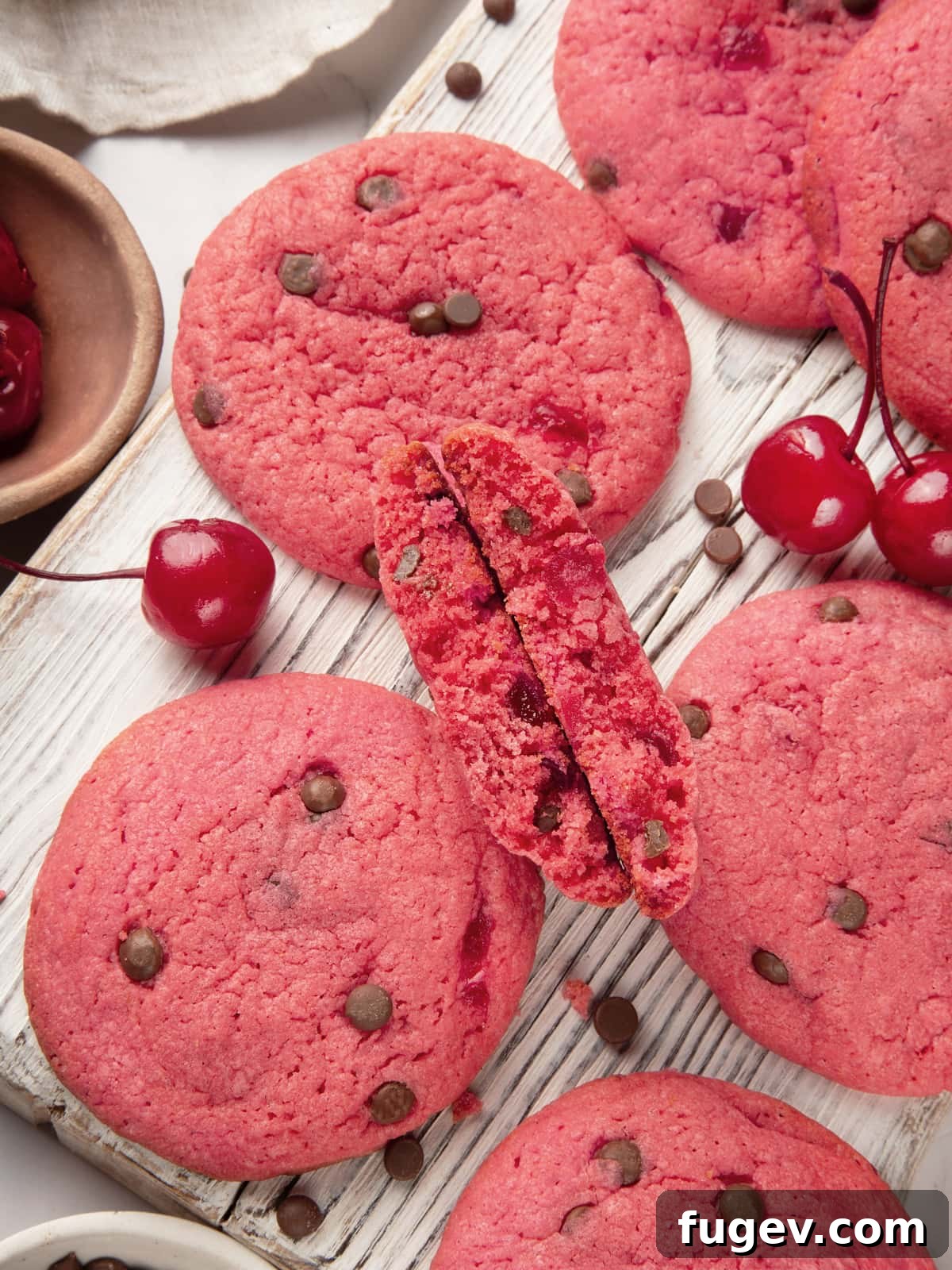 Luscious Cherry Chocolate Chip Cookies 2 Broken cherry chocolate chip cookie revealing thick center and abundant chocolate chips and cherry pieces.
