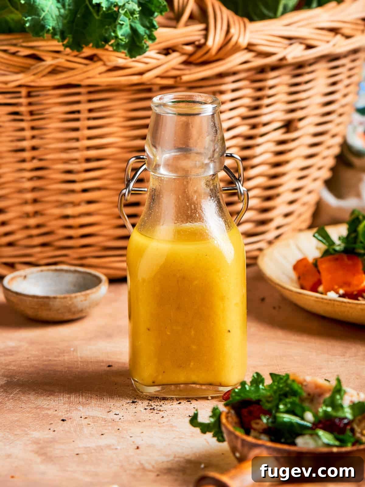Sparkling Champagne Vinaigrette 2 Bottle of homemade champagne vinaigrette standing in front of a woven kitchen basket, ready to be used.