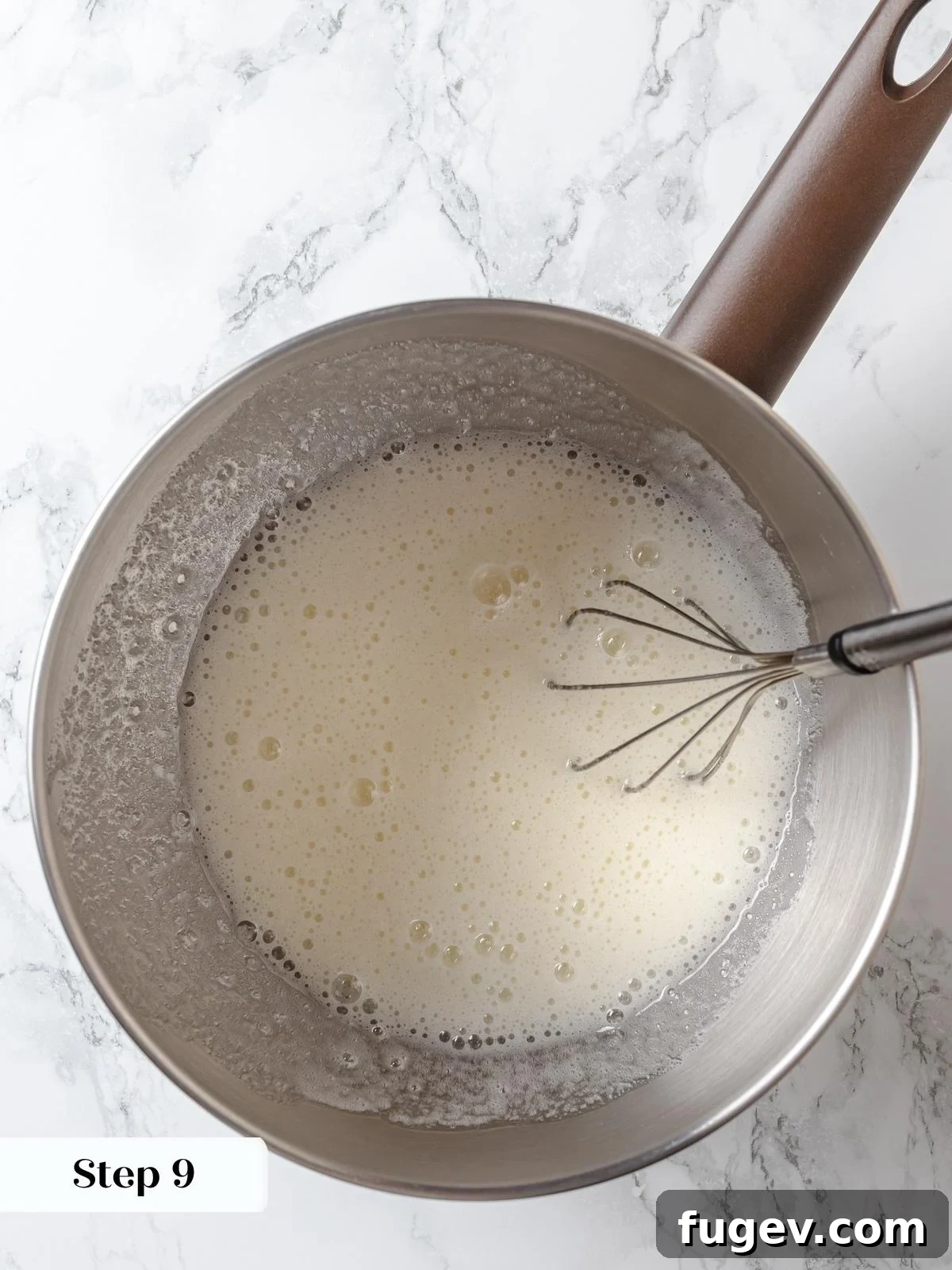 Egg whites and sugar gently cooking over a bain-marie, forming the foundation of a stable and silky Swiss meringue, perfect for buttercream.