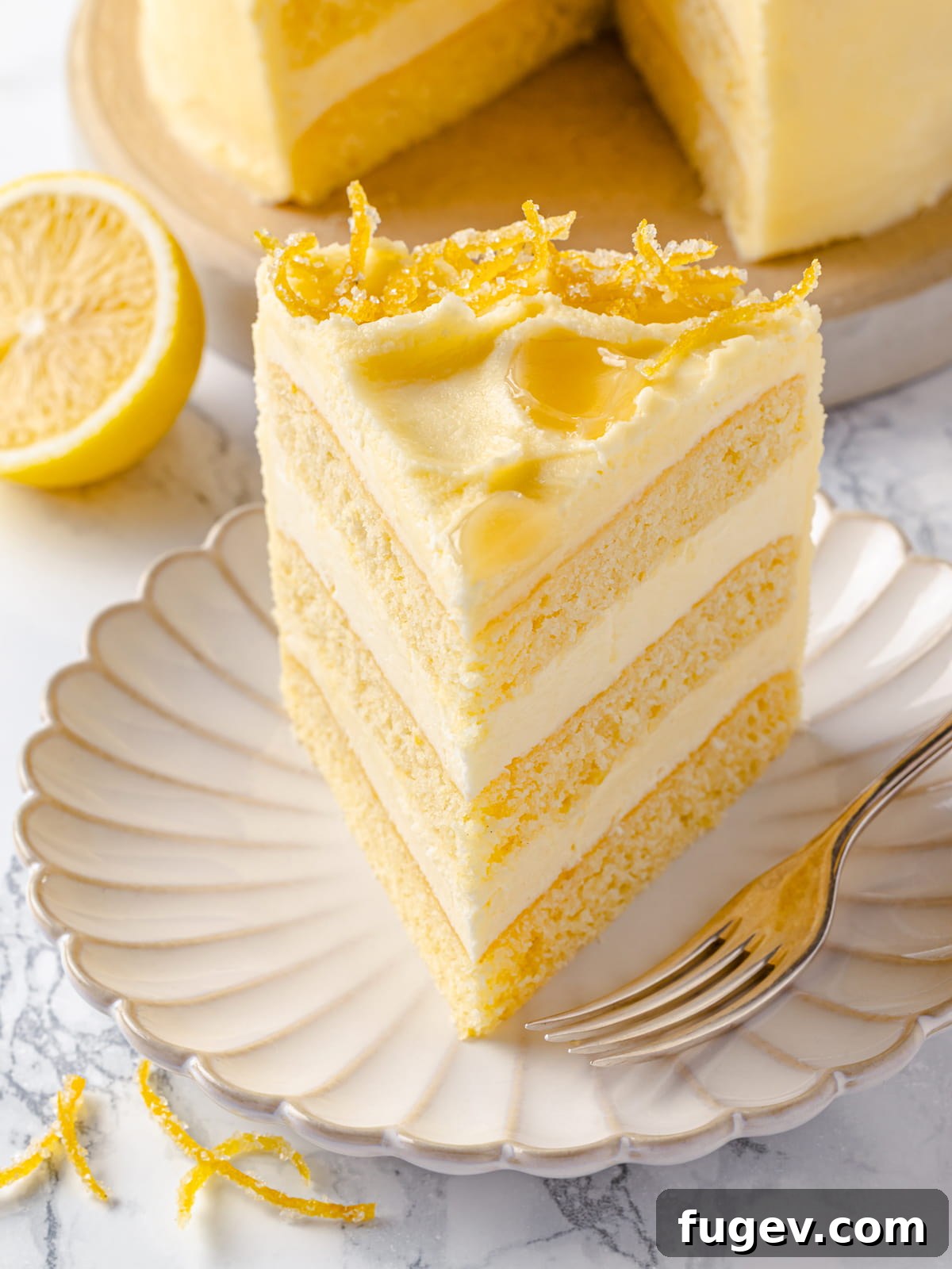 A beautiful single slice of lemon cake, showcasing its fluffy buttercream and exceptionally tender crumb, perfectly displayed for enjoyment.