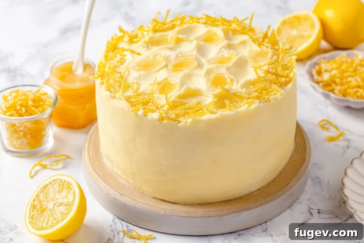 A beautifully decorated lemon cake, adorned with delicate curls of fresh lemon peel and artful swirls of smooth buttercream, ready to be served.