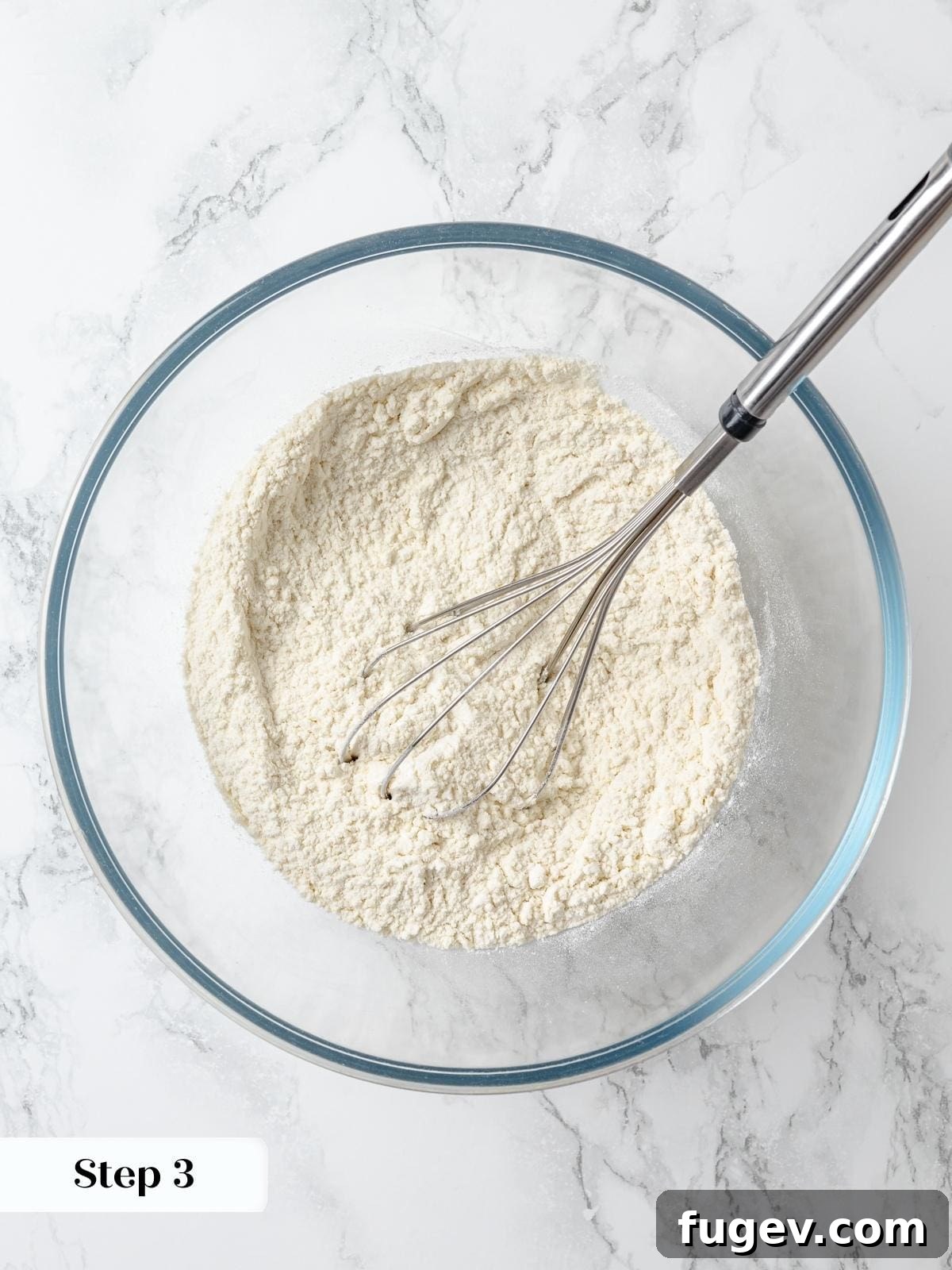 A whisk combines cake flour, baking powder, and salt, ensuring an even distribution of dry ingredients for a consistent lemon cake batter.