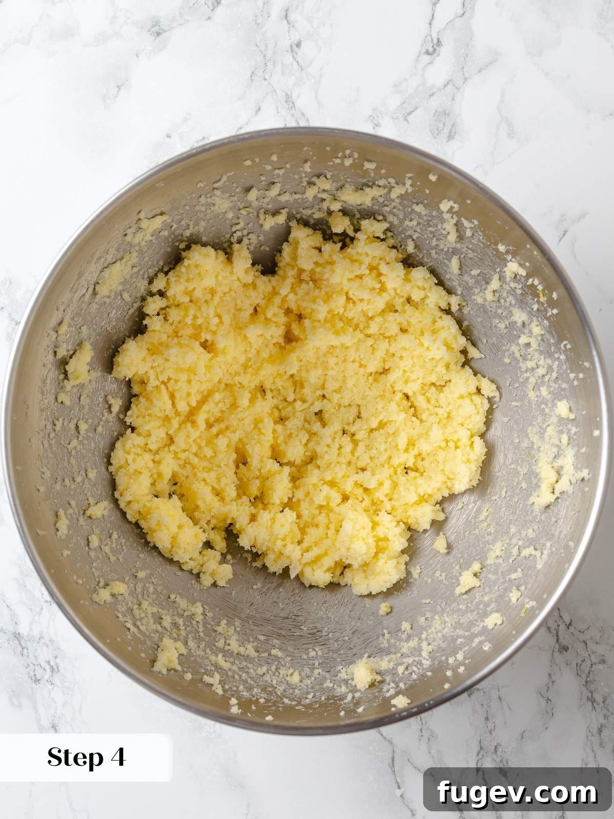 Butter creaming with fragrant citrus-infused sugar, forming a light and fluffy base that builds structure for the lemon cake.