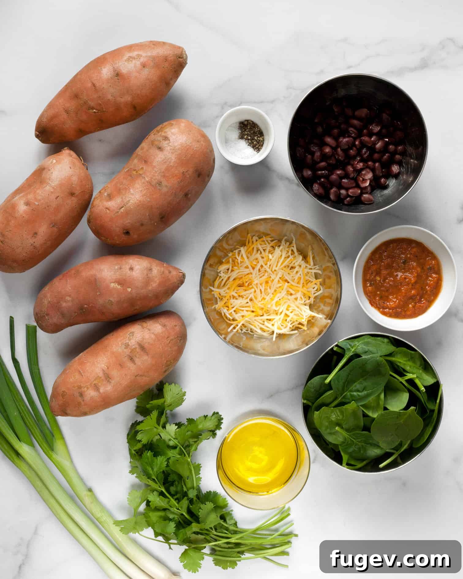 Sweet Potato Boats 4 A colorful array of ingredients for sweet potato skins including whole sweet potatoes, black beans, spinach, scallions, cilantro, and shredded cheese