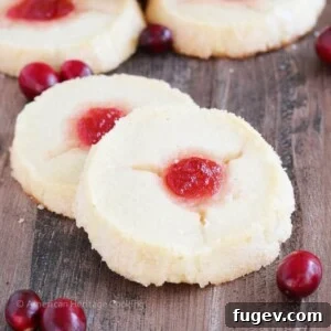 Cranberry Thumbprint Cookies on a rustic wood slate, ready to be enjoyed.