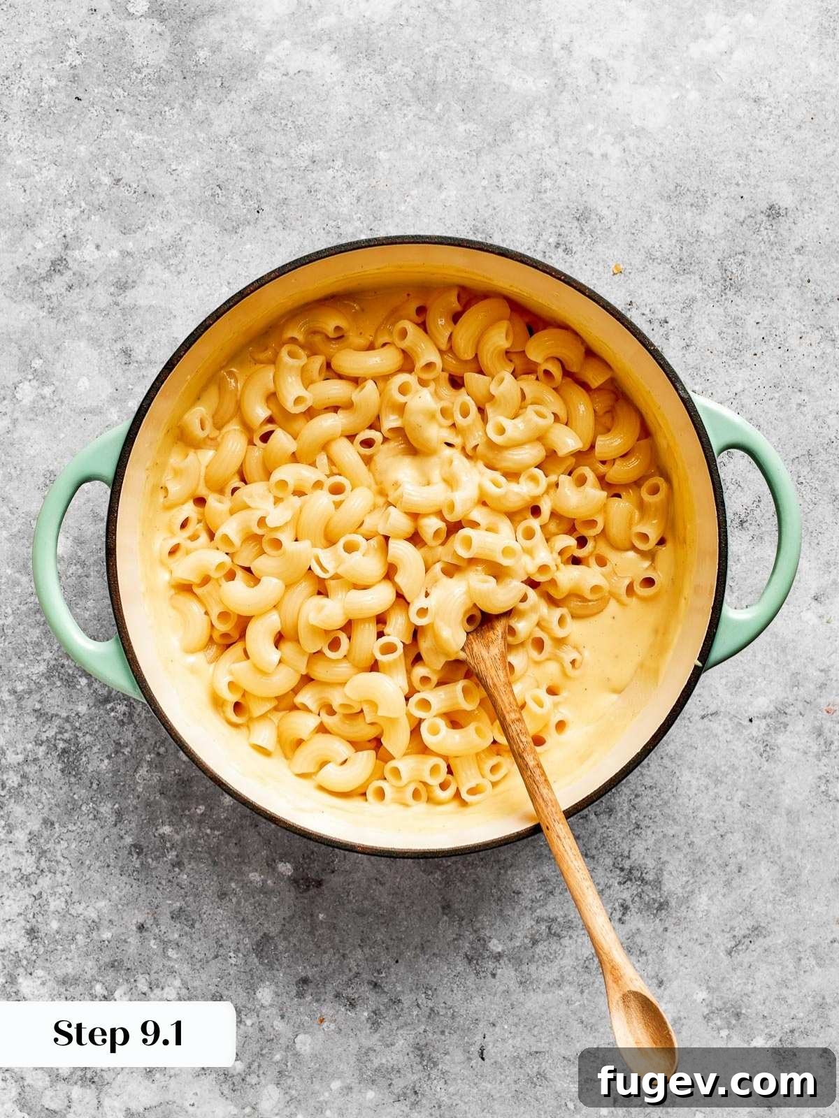 Golden Crusted Baked Mac and Cheese 14 Cooked pasta being lovingly mixed into the velvety, creamy cheese sauce, ensuring every piece is coated.