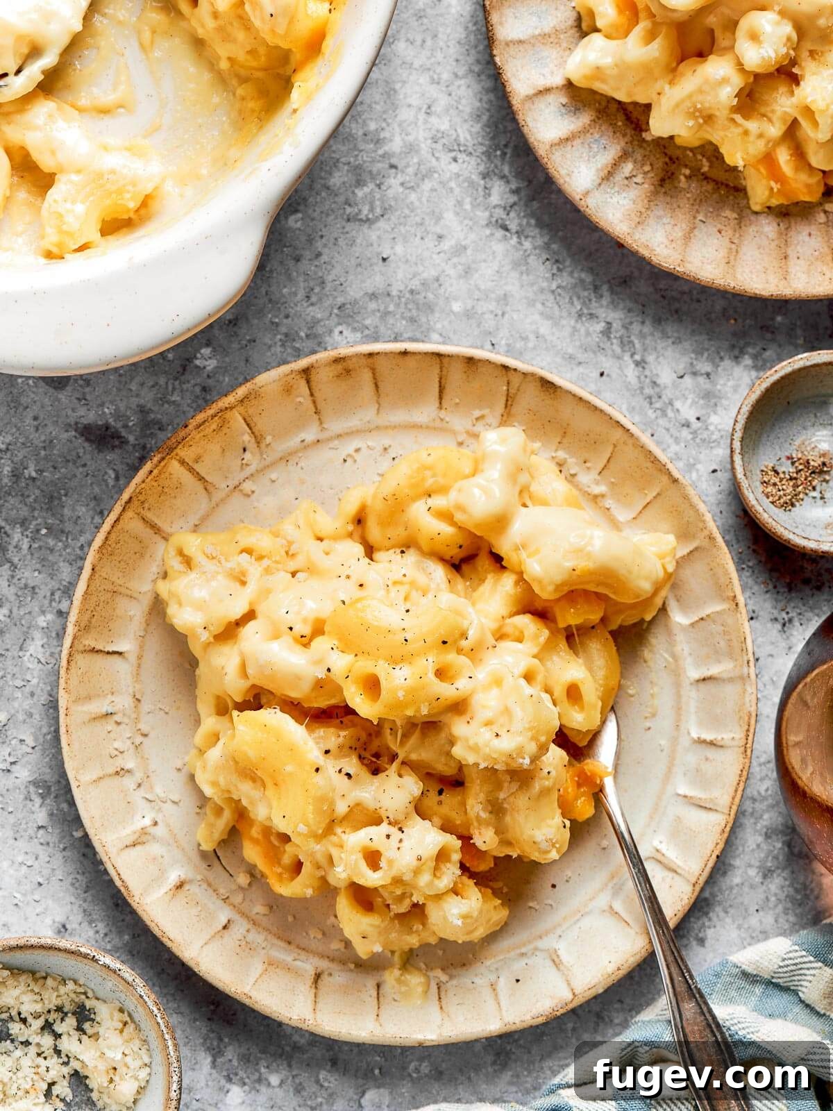 Golden Crusted Baked Mac and Cheese 18 A beautifully plated serving of cheesy mac and cheese, garnished and ready to be enjoyed on a rustic countertop.