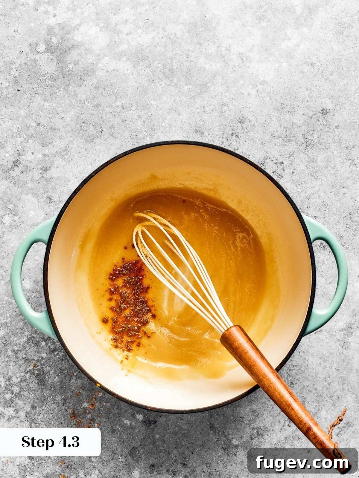 Golden Crusted Baked Mac and Cheese 8 A whisk continuously stirring the flour and butter mixture over low heat, ensuring a smooth, lump-free roux.