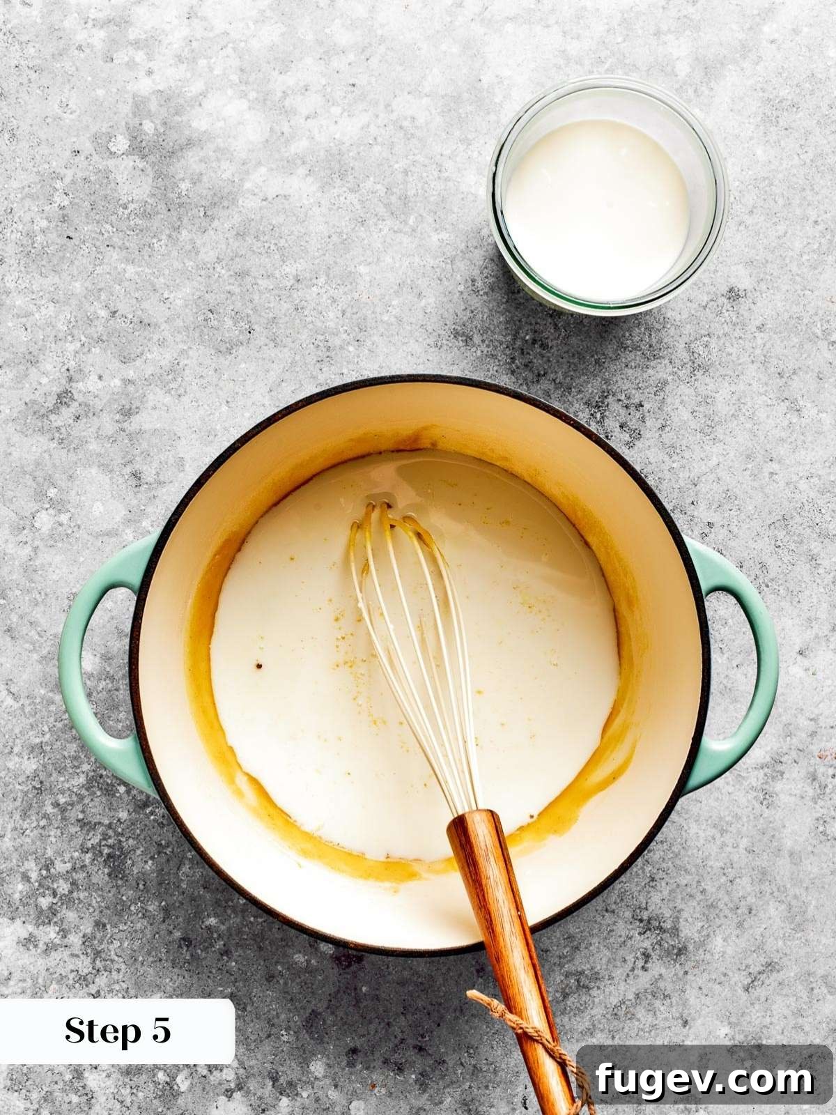 Golden Crusted Baked Mac and Cheese 9 Milk being slowly and carefully added to the thickened roux, creating a silky-smooth sauce.
