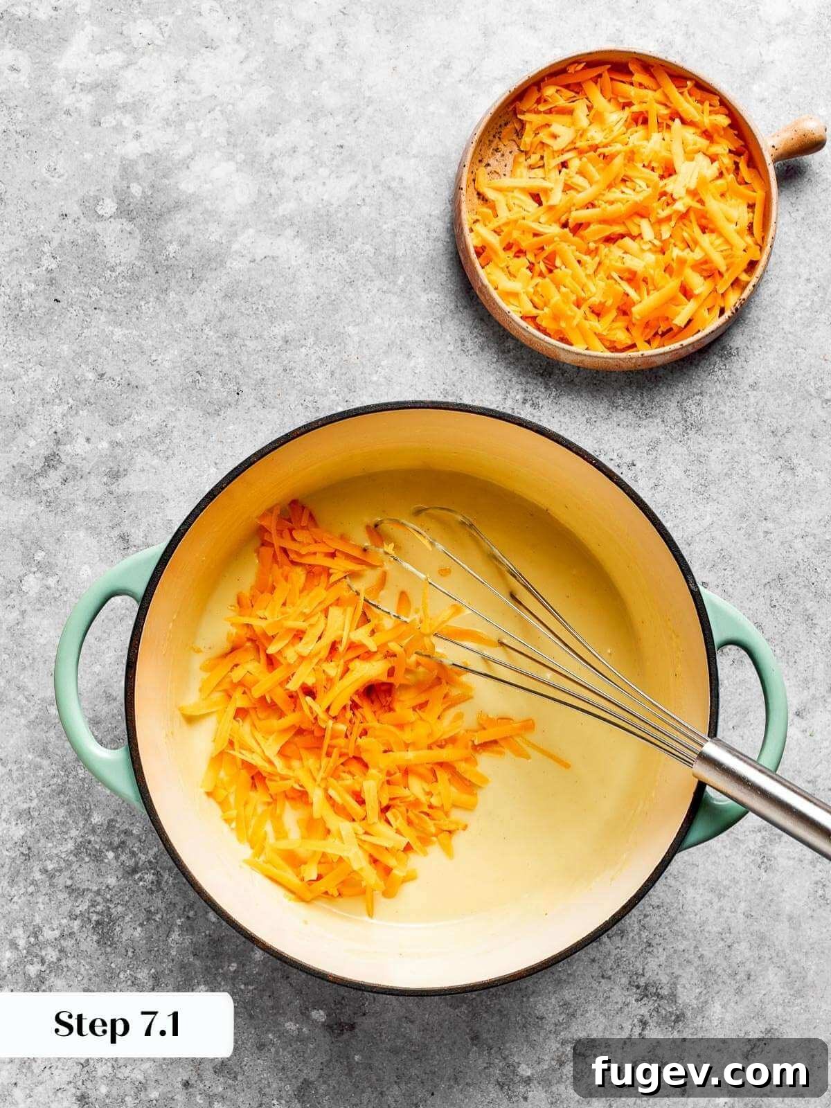 Golden Crusted Baked Mac and Cheese 10 Shredded sharp cheddar cheese gracefully melting into the rich, thickened roux, forming a cohesive and decadent cheese sauce.