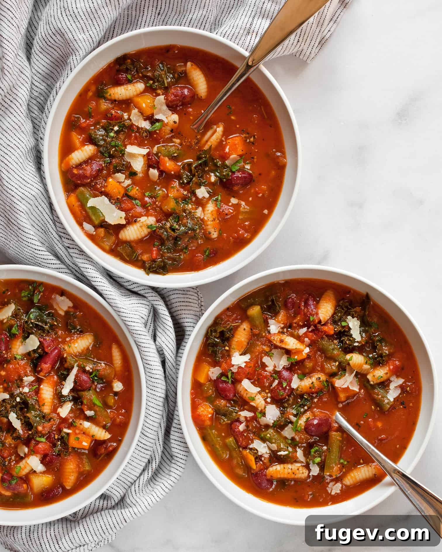 Wholesome Garden Minestrone 2 A steaming bowl of vibrant vegetarian minestrone soup, garnished with fresh herbs and a sprinkle of Parmesan.