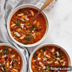 Wholesome Garden Minestrone 7 Three individual bowls of vibrant vegetarian minestrone soup, garnished with fresh herbs and a drizzle of olive oil.