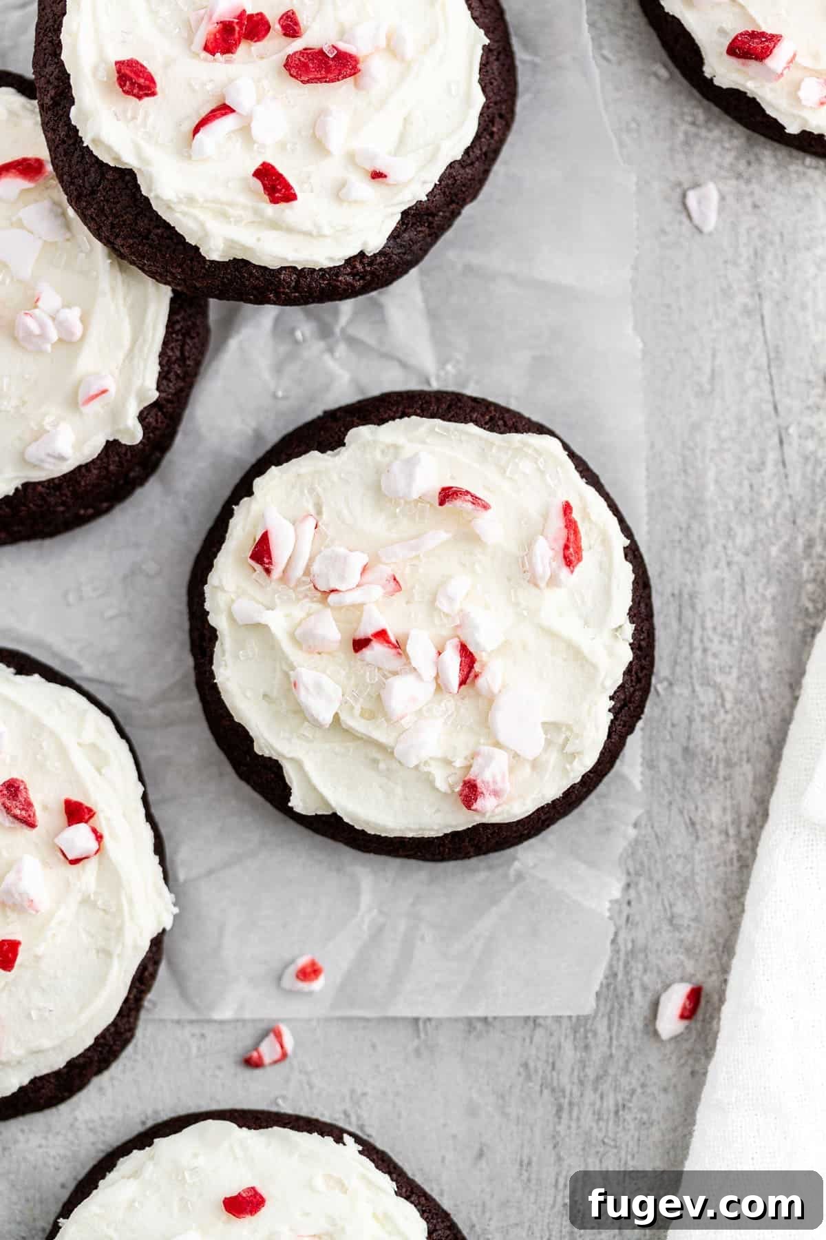 16 Festive Chocolate Christmas Cookies 14 Decadent iced chocolate cookies, generously topped with vibrant crushed peppermint candies, a truly festive treat.