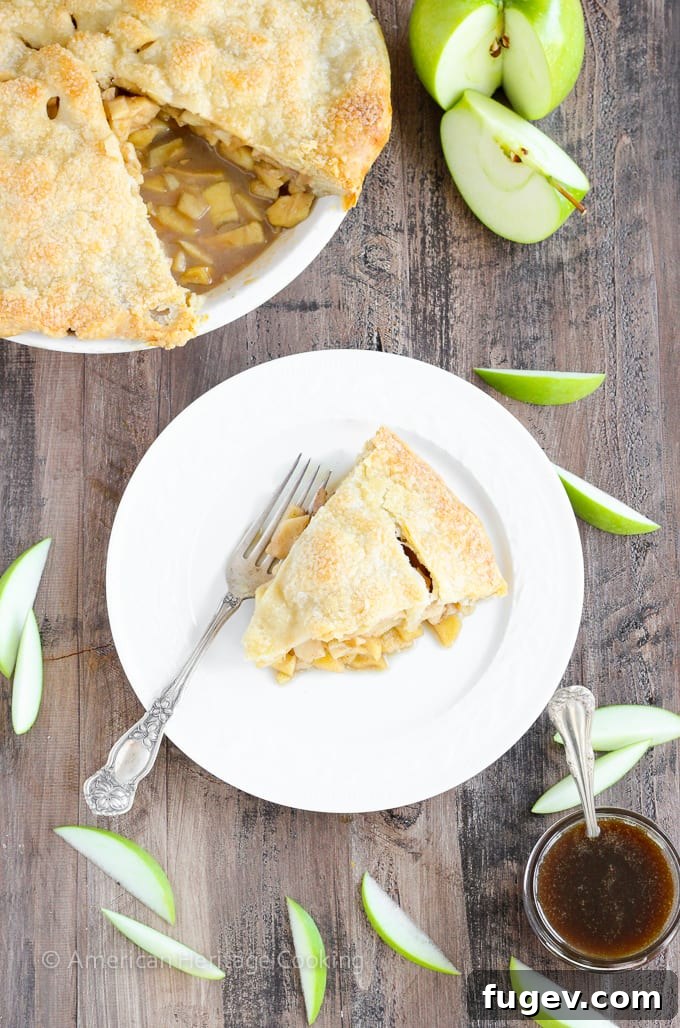 Creamy Butterscotch Apple Tart 3 A stunning overhead shot of an unbaked Apple Butterscotch Pie, showcasing the beautifully crimped edges of the top crust.