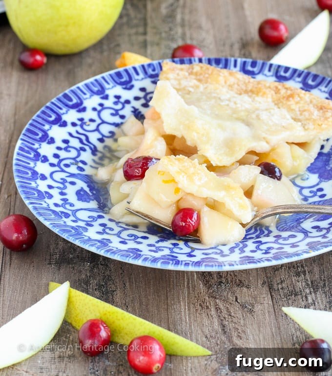 Vibrant Cranberry Orange Pear Pie 4 A whole Cranberry Orange Pear Pie, freshly baked with a golden crust and a glistening sugared top.