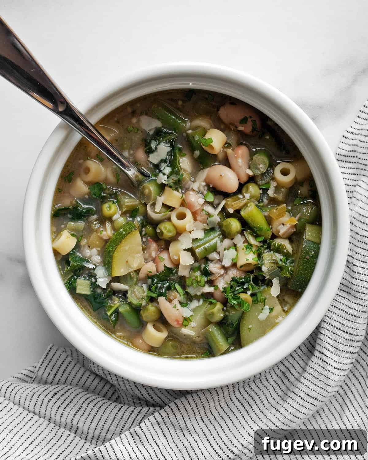 Vibrant Garden Minestrone 2 Bowl of vibrant spring minestrone soup, rich with green vegetables and pasta.
