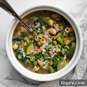 Vibrant Garden Minestrone 8 A beautifully presented bowl of green minestrone soup, highlighting its fresh ingredients and comforting appeal.