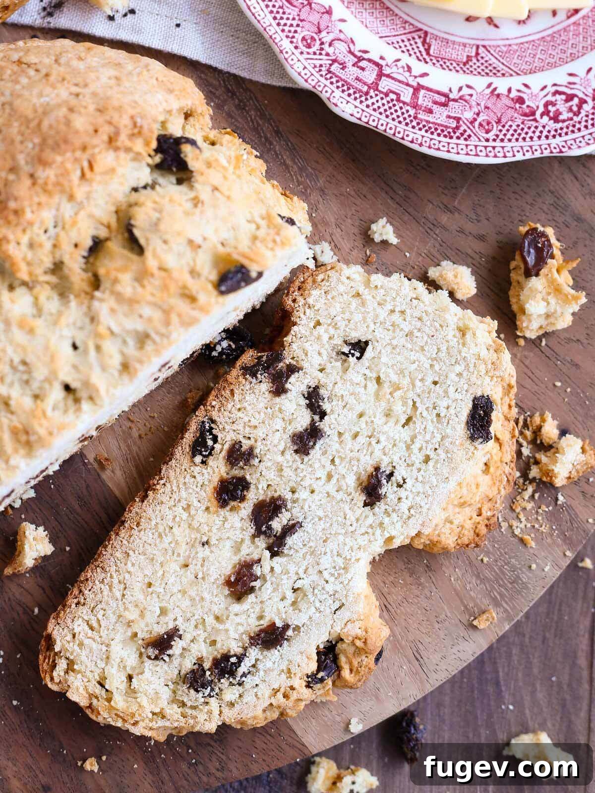 Simple Sweet Irish Raisin Bread 3 A perfectly sliced piece of traditional Irish soda bread with visible raisins and a tender crumb.
