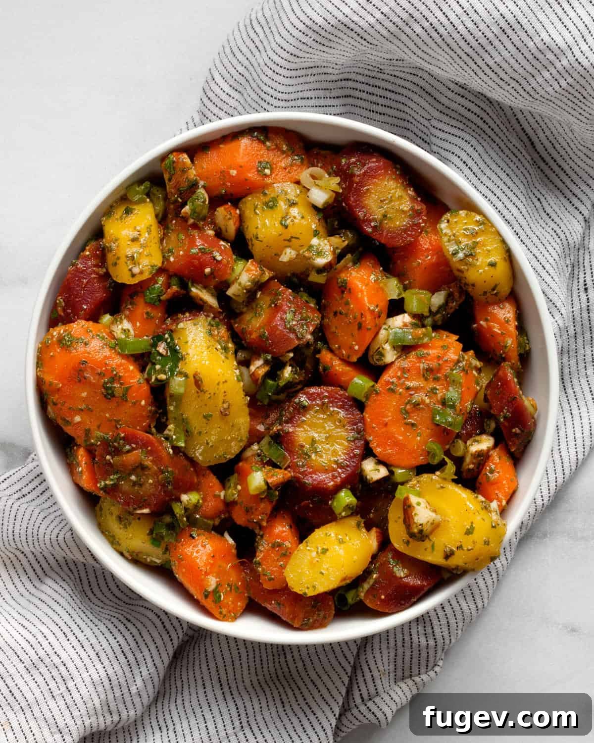 Bright Moroccan Carrot Salad 2 A beautifully presented Moroccan carrot salad in a bowl, garnished with almonds and scallions, showcasing its vibrant colors and inviting texture.