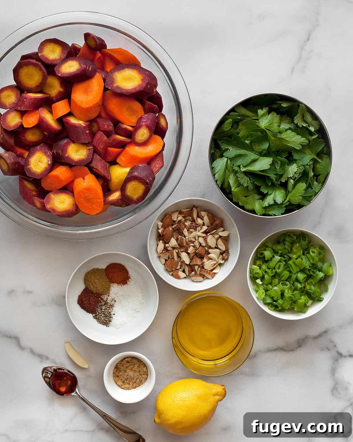 Bright Moroccan Carrot Salad 3 A flat lay photograph showcasing all the fresh ingredients required for the Moroccan carrot salad, including colorful rainbow carrots, fresh herbs, scallions, almonds, a lemon, olive oil, and various spices.
