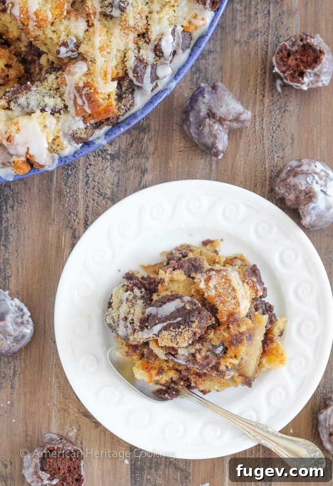 Decadent Coffee Donut Pudding 5 A close-up of a serving of Coffee Donut Bread Pudding, showing the moist interior and a drizzle of glaze.